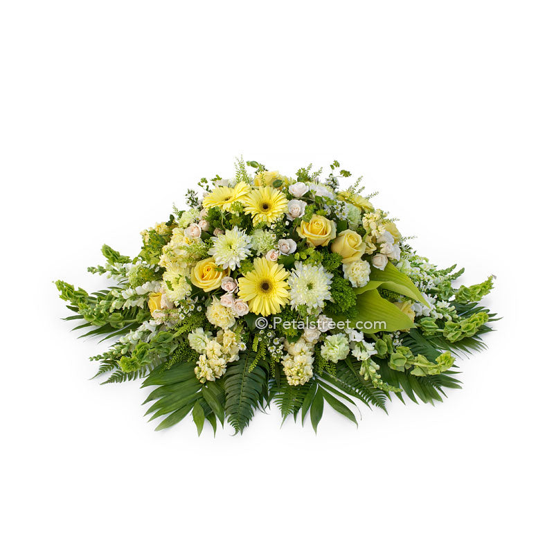 Soft yellow, white, and green casket spray with Daisies, Mums, and Roses by Petal Street Flower Company.