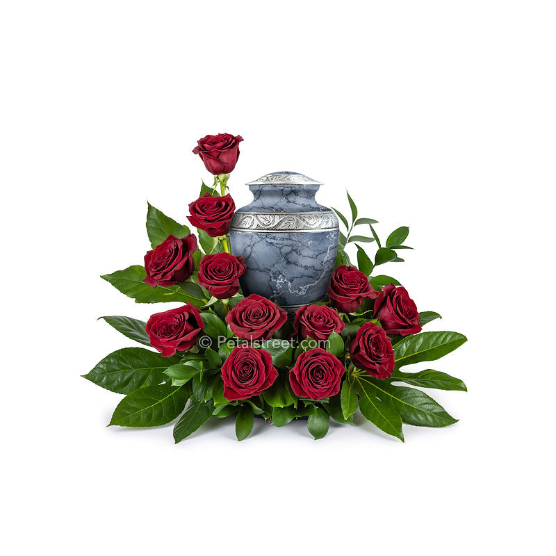 Circular arrangement of red Roses and foliage made for a cremation urn which can be placed in the center.
