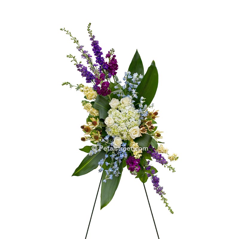 Stylish standing spray custom shaped has Roses, Hydrangea, and Delphinium, a beautiful piece to have delivered.