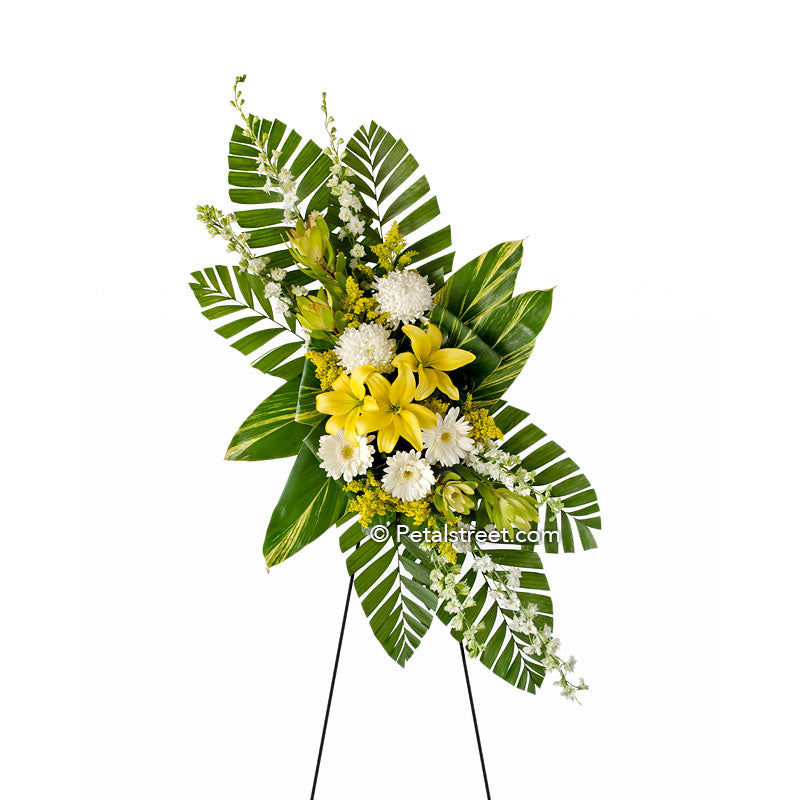 Yellow Lilies and white accent flowers in a funeral standing spray by Petal Street Flower Company, Point Pleasant florist.