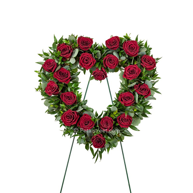 Open Heart funeral wreath with red Roses, Eucalyptus, and mixed foliage accents.