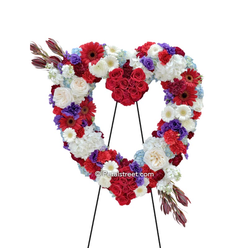Red, white, blue funeral flower heart form with Roses, Daisies, Carnations, Hydrangea, and Lisianthus.
