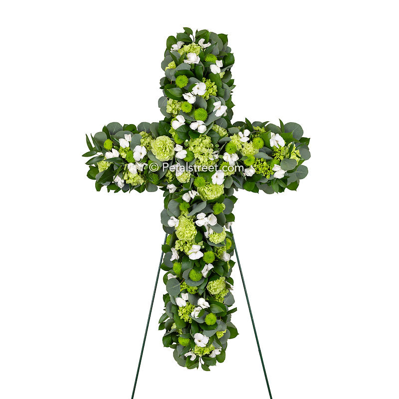 A beautiful funeral cross and an excellent Irish funeral cross with green and white flowers and lush accent foliage.