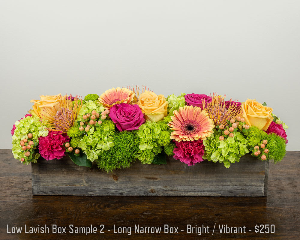 An extra wide and narrow garden box container featuring vibrant Roses, Daisies, Protea, hydrangea, and hypericum Berries