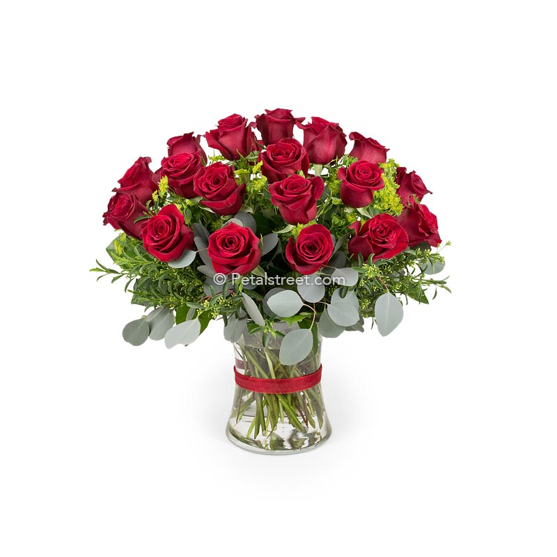 A classic sympathy vase of two dozen red Roses with Eucalyptus and Bupleurum accents.