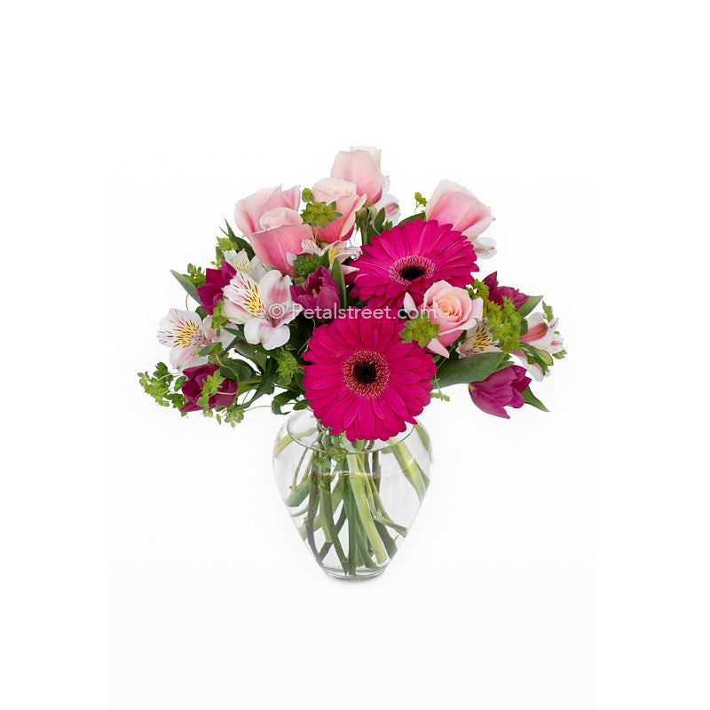 Mixed vase arrangement in a variety of pinks. Gerbera Daisies, Roses, Alstromeria, and accents.