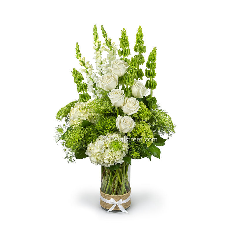 Gorgeous Irish flower arrangement with green and white flowers such as Roses, Bells of  Ireland, Hydrangea, and Snap Dragons.