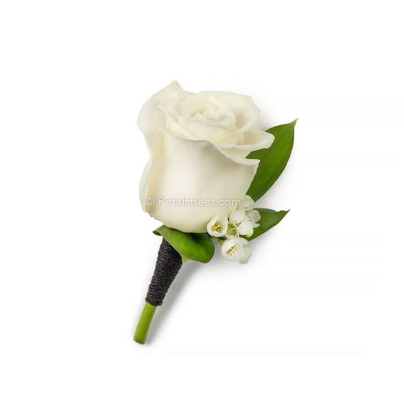 A classic white Rose boutonniere with mini white flower accent, mini leaf accents and tuxedo black mini twine elegantly wrapped around stem for a sleek finish - made by Petal Street Flower Company florist Point Pleasant, NJ