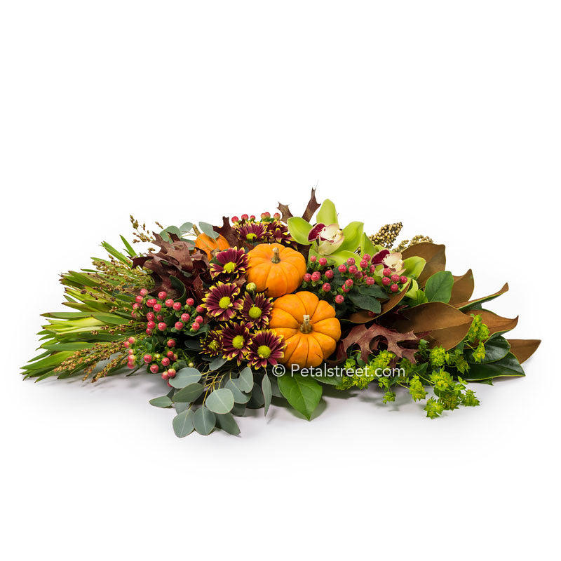 Thanksgiving flowers centerpiece with Daisy Mums, green Orchids, red Berries, mini Pumpkin Gourds with a mix of seasonal foliage such as Magnolia  and Oak Leaves.