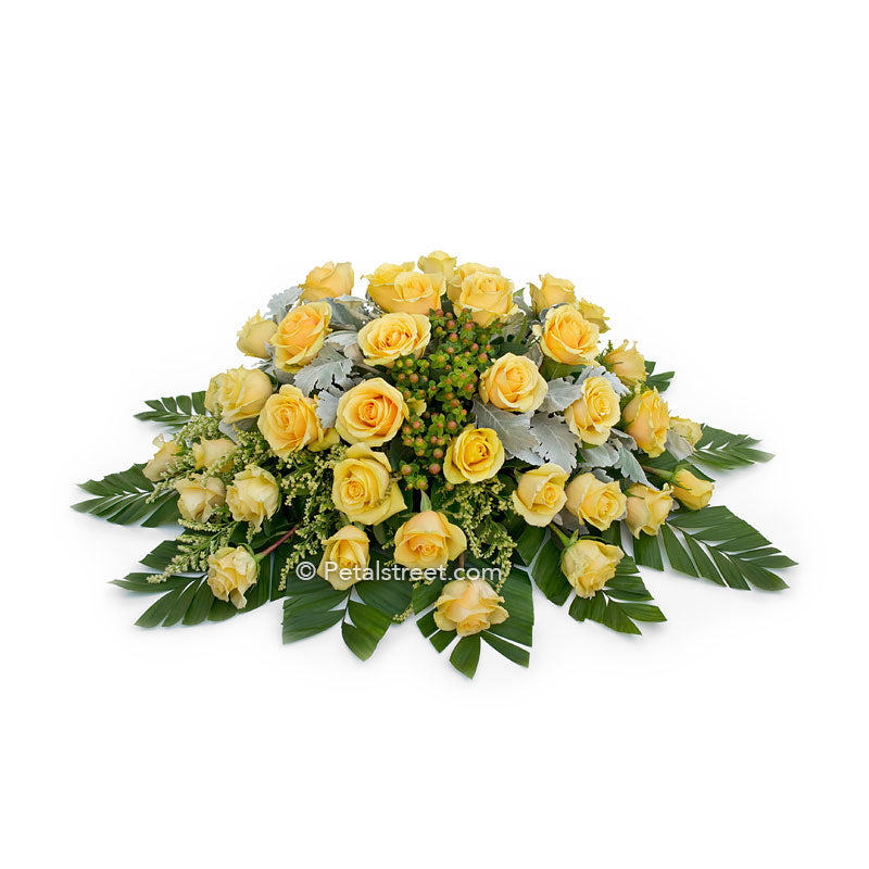 Casket spray with yellow Roses for family funeral viewing.