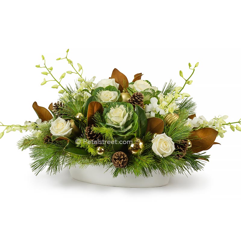 Gorgeous upscale Christmas holiday flower arrangement with whites and greens featuring kale and roses mixed with magnolia leaves and seasonal greenery arranged in a white ceramic container by petal street flower company florist in Point Pleasant NJ