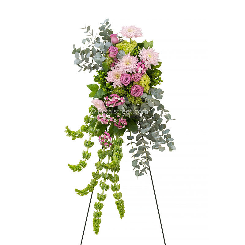 Cascading standing spray with pink Roses, Mums, and Sweet William, green Hydrangea, Eucalyptus, and Bells of Ireland.
