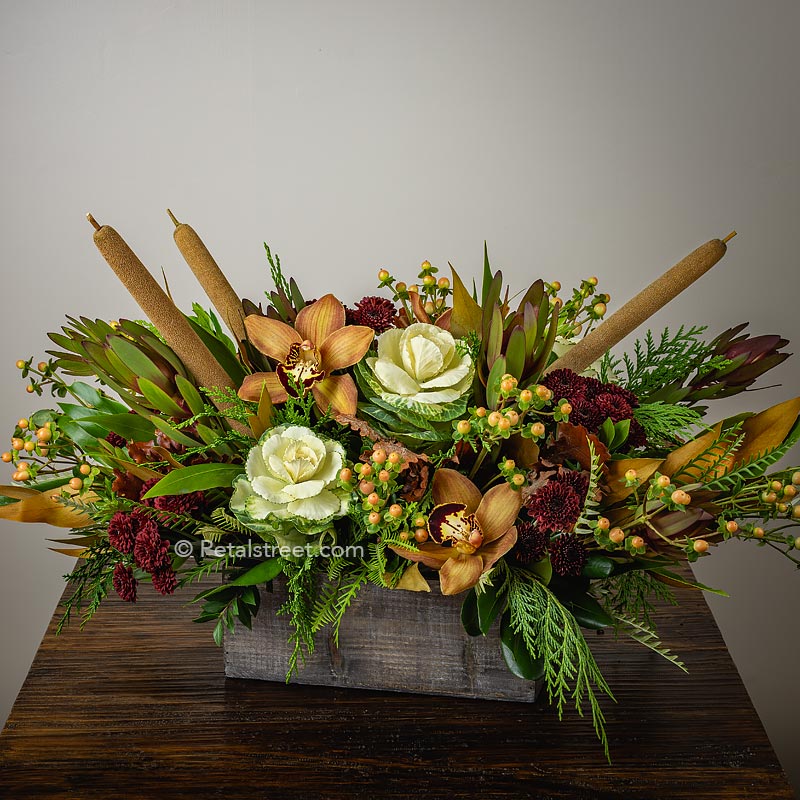 Fall flower table centerpiece with bright Kale, soft brown Orchids, Cat Tails, Berry Accents and mixed foliage by Petal Street Flower Company Florist in Point Pleasant NJ