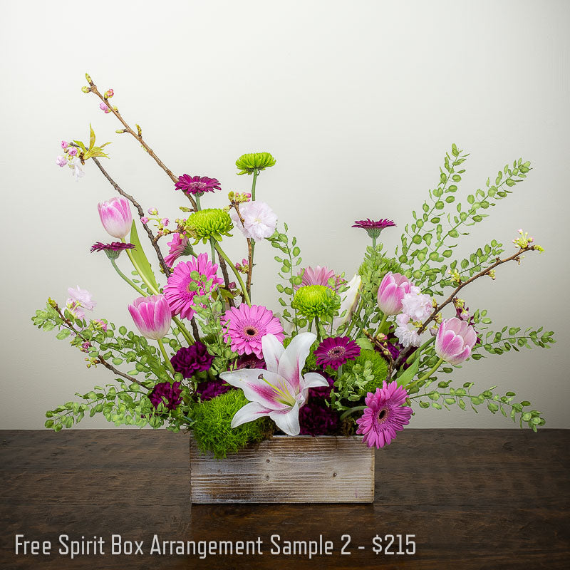 Pink, burgundy, and white garden box flower arrangement with Lilies, Tulips, Daisies, Spider Mums, assorted branches and accent foliage