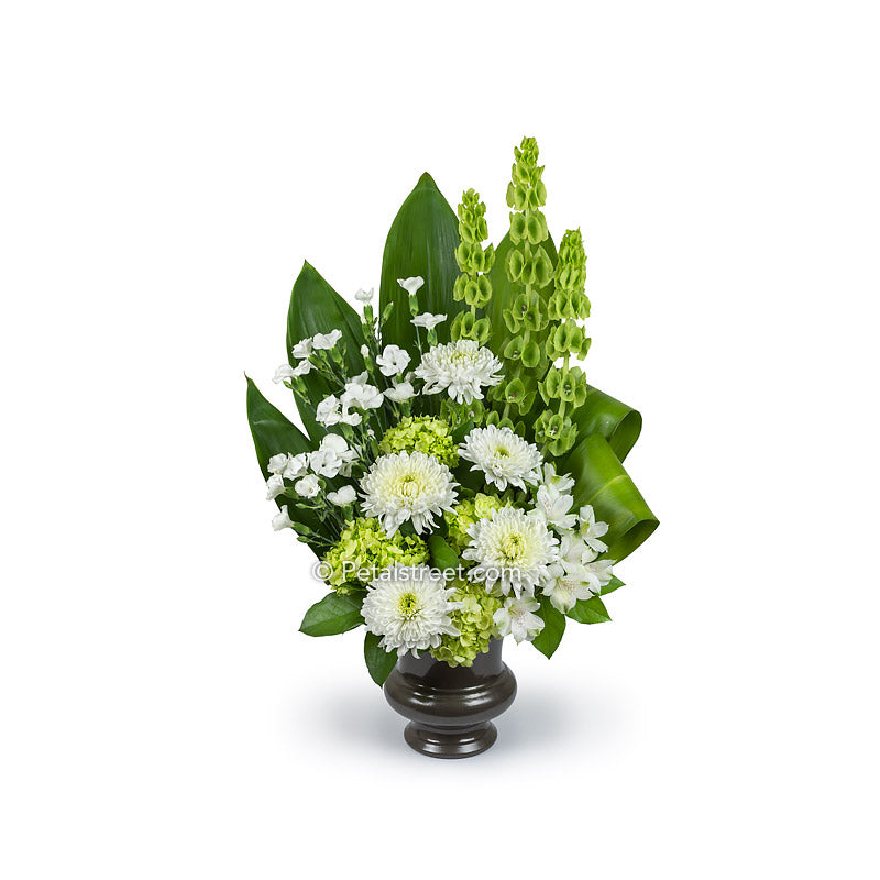 Funeral Basket with white Mums, Dianthus, and Alstromeria, green Hydrangea, Bells of Ireland, Ti Leaves, and accent greener.