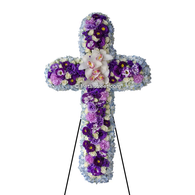 Funeral cross with white Orchids, mixed purple flowers, and blue Hydrangea, a beautiful piece.