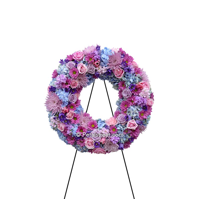 Funeral wreath in soft purple tones with Roses, Hydrangea, and Spider Mums.