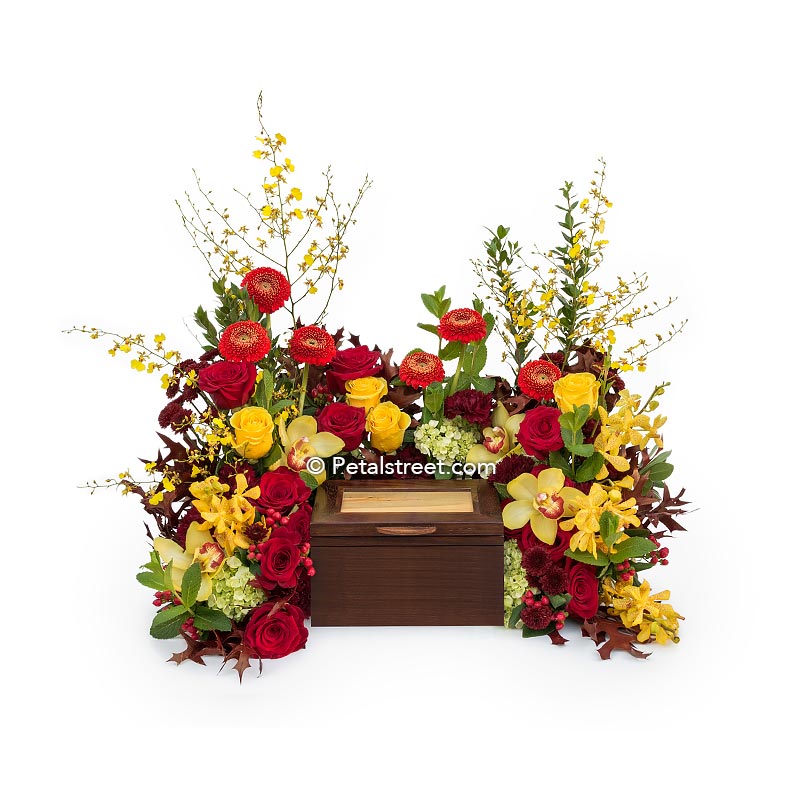 Beautiful cremation urn flowers by Petal Street Flower Company, a Point Pleasant, NJ florist. Yellow Roses, orange Daisies, and stunning Orchids.