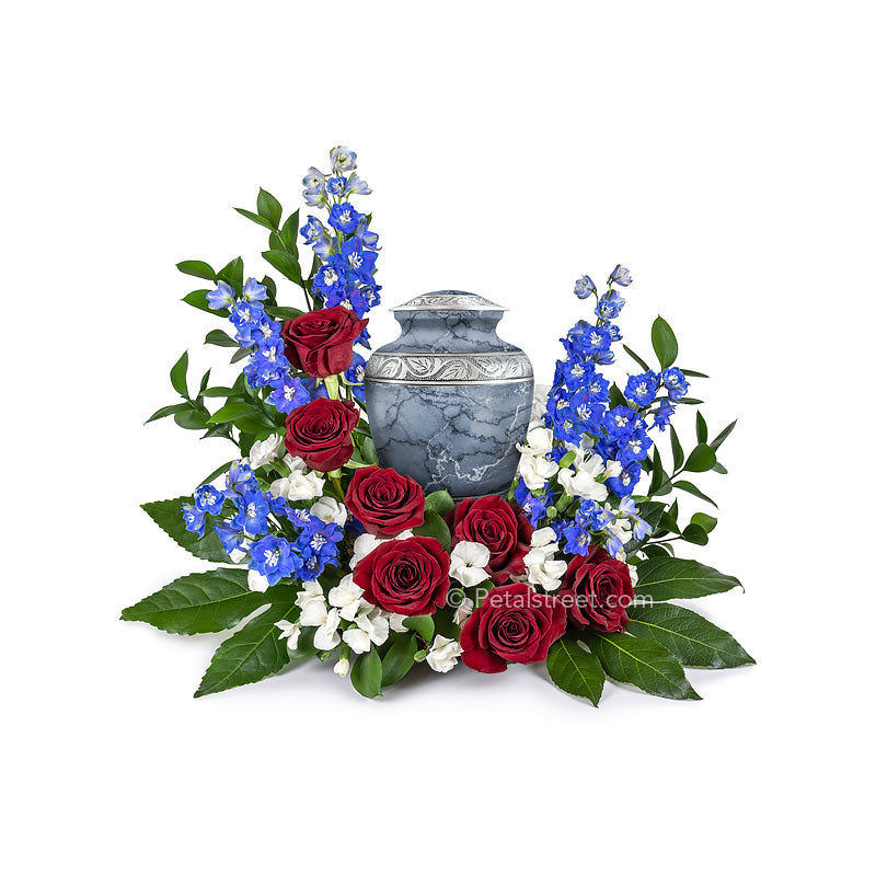 Patriotic red, white, and blue flowers for cremation urn with Roses, Dianthus, and Delphinium accented with lush greenery.
