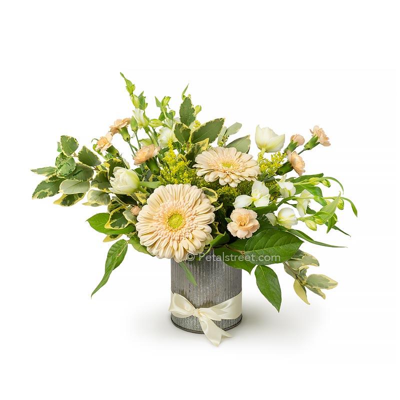A hand gathered mix of flowers with Gerbera Daisies, Alstromeria, mini Carnations, and Tulips, arranged in a stylish tin cylinder.
