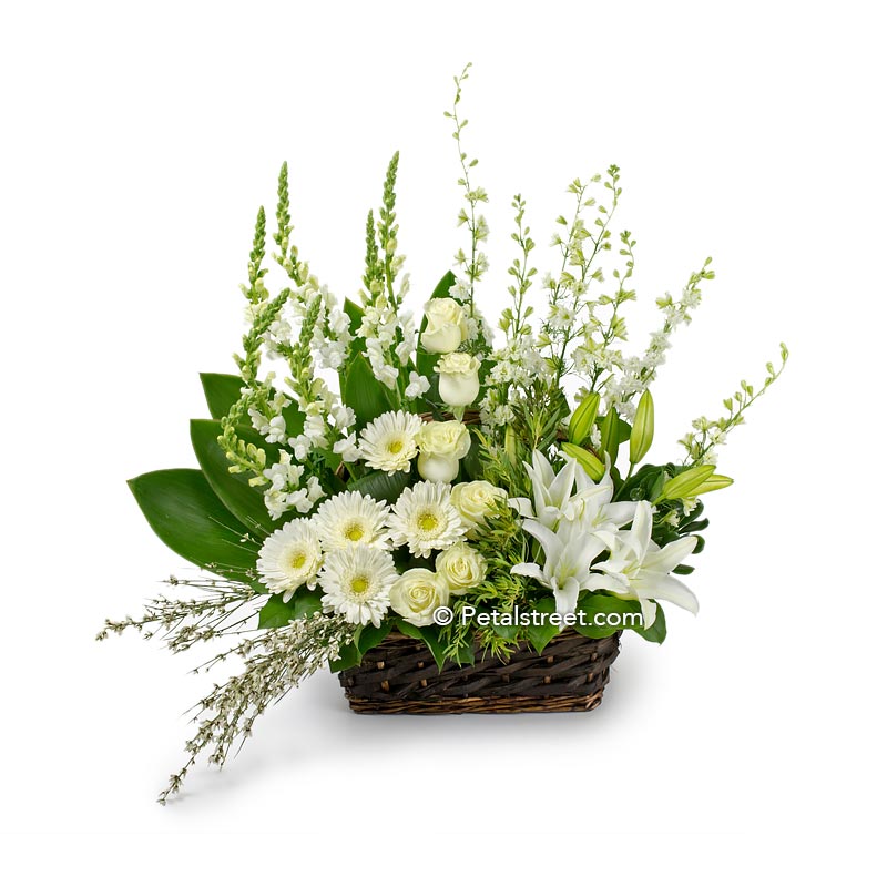 Gorgeous garden style sympathy flower basket with white Gerbera Daisies, Roses, Lilies,  Snapdragons, and accent greenery.
