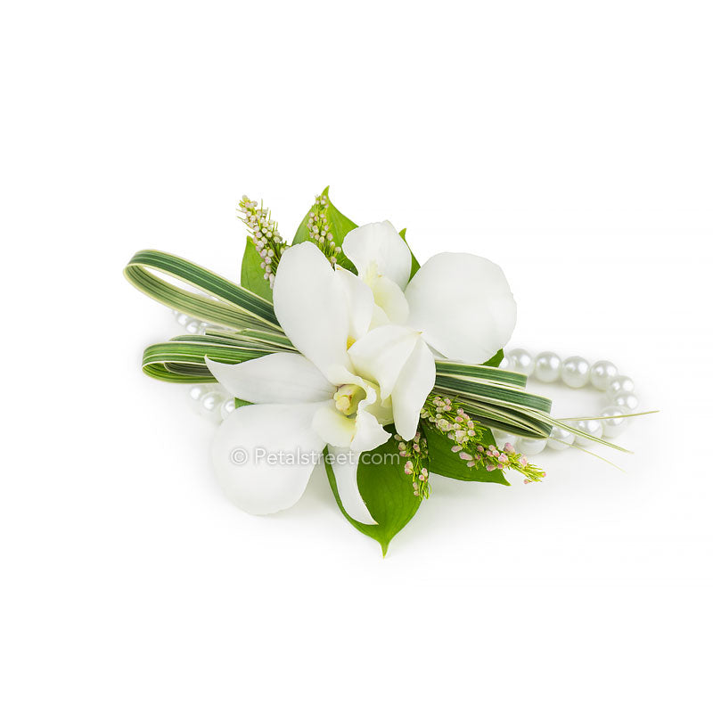 White Orchid prom corsage with petite greenery accents on a pearl bracelet by Point Pleasant NJ florist Petal Street Flower Company