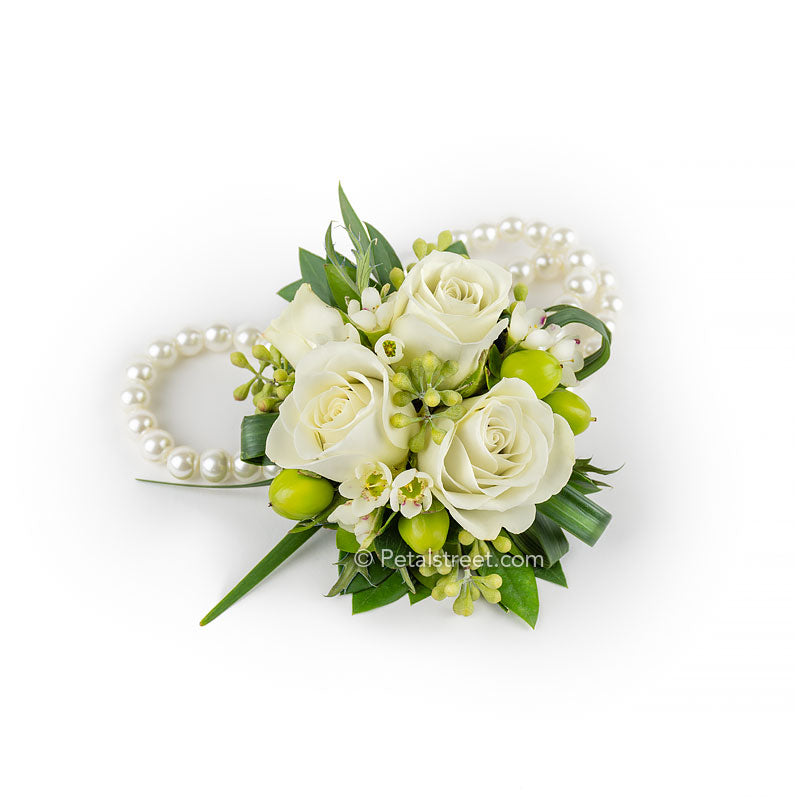 White prom flower wristlet with mini Roses on a pearl bracelet by Petal Street Flower Company florist in Point Pleasant New Jersey